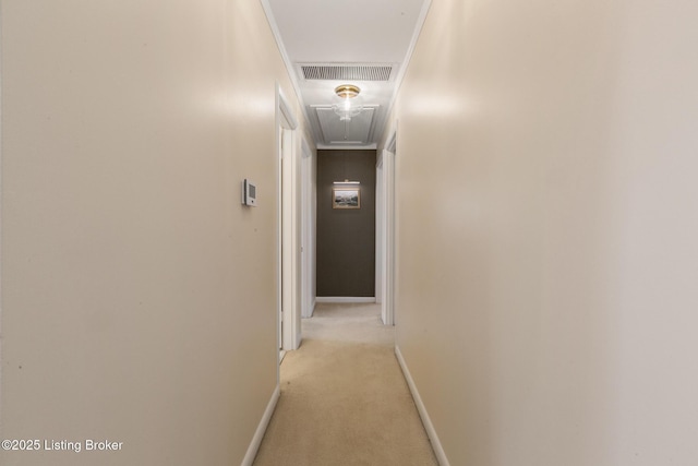 hall featuring attic access, light carpet, visible vents, and baseboards