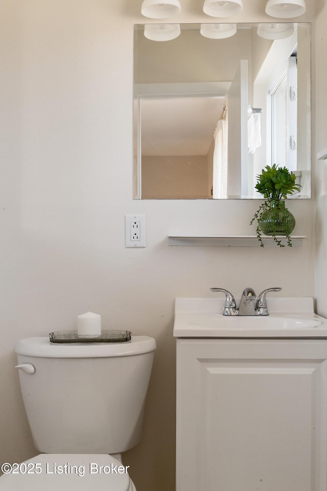 bathroom featuring toilet and vanity