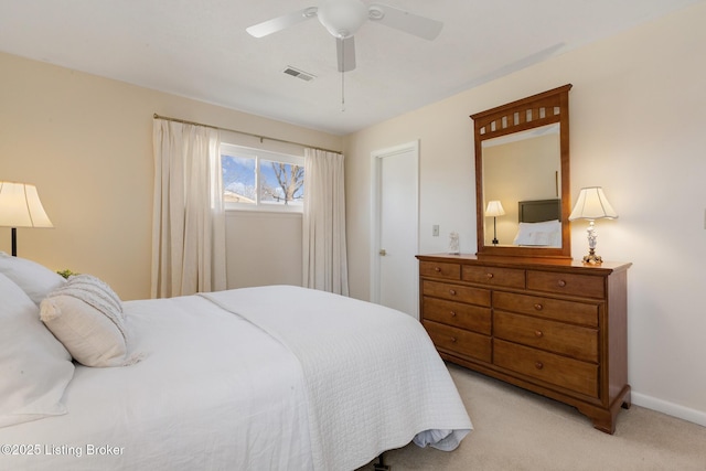 bedroom with light carpet, visible vents, baseboards, and a ceiling fan