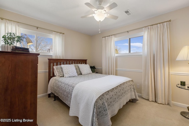 bedroom featuring light colored carpet, visible vents, ceiling fan, and baseboards