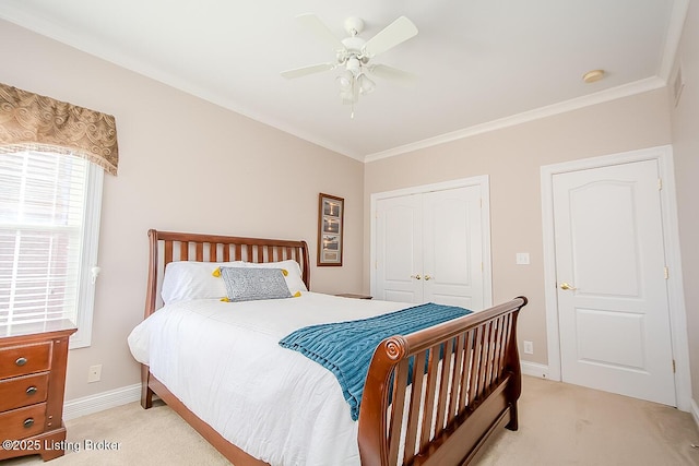 bedroom featuring light carpet, crown molding, baseboards, and a closet