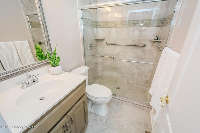 bathroom featuring toilet, a stall shower, marble finish floor, and vanity