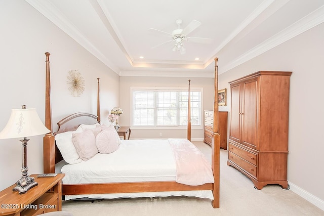 bedroom with crown molding, a raised ceiling, a ceiling fan, light carpet, and baseboards