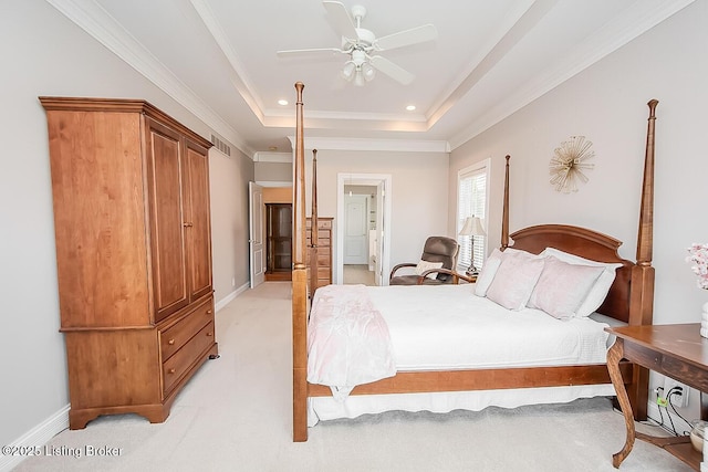 bedroom featuring light colored carpet, visible vents, baseboards, ornamental molding, and a tray ceiling