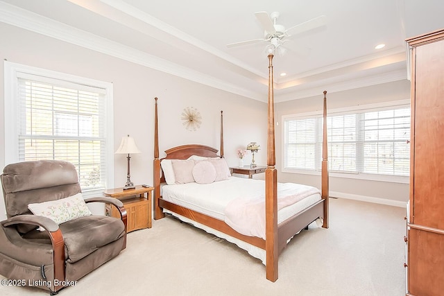 bedroom featuring ornamental molding, a raised ceiling, and light colored carpet