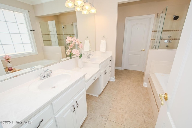 bathroom with tile patterned floors, a sink, a shower stall, and double vanity