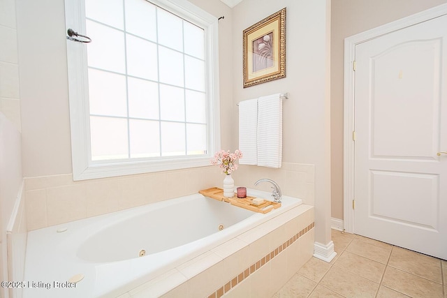 bathroom with a whirlpool tub and tile patterned flooring