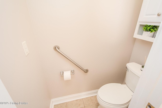 bathroom with toilet, tile patterned flooring, and baseboards