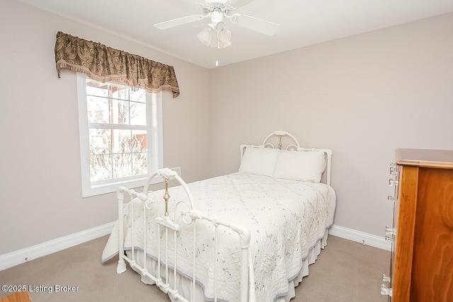 bedroom with light carpet, ceiling fan, and baseboards