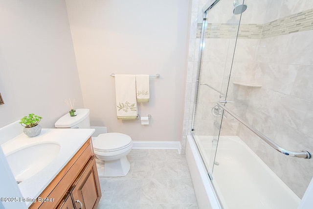 full bathroom featuring toilet, baseboards, combined bath / shower with glass door, and vanity