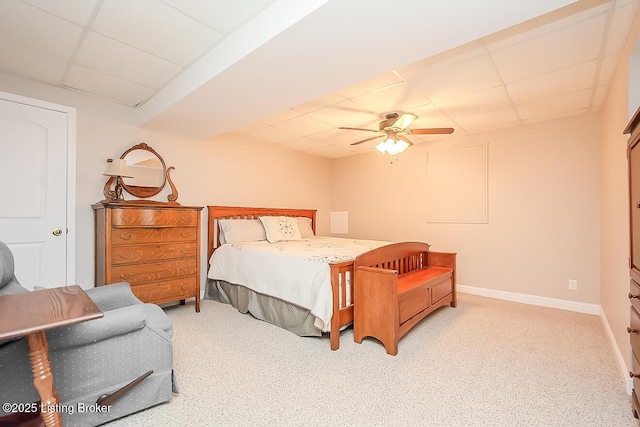 bedroom with carpet floors, a paneled ceiling, baseboards, and a ceiling fan