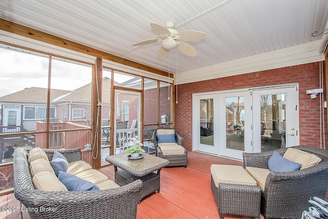 sunroom with plenty of natural light and a ceiling fan