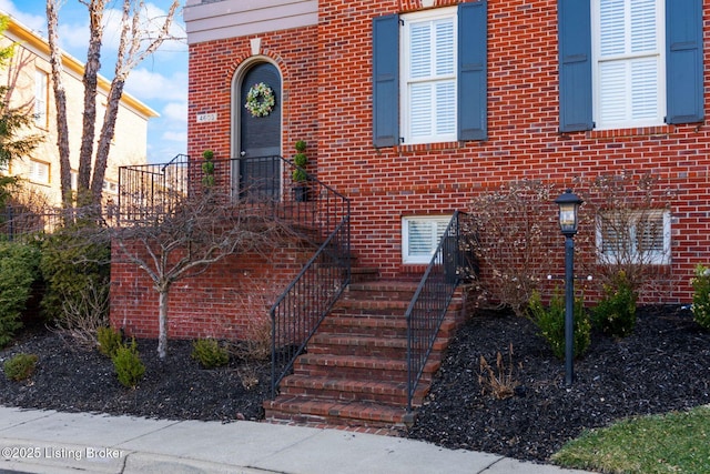 property entrance with brick siding