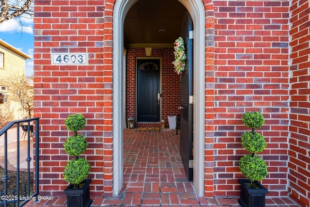 entrance to property with brick siding