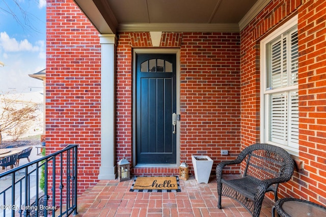 entrance to property featuring brick siding