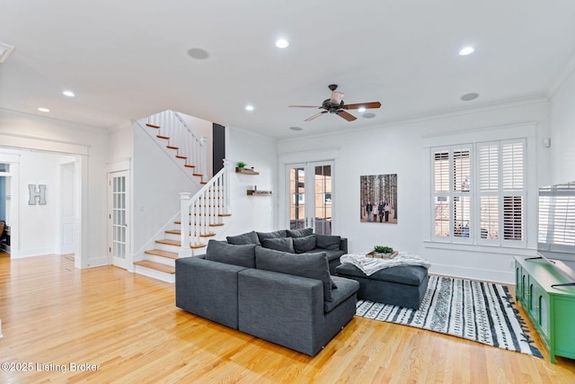 living room featuring recessed lighting, stairs, french doors, light wood finished floors, and crown molding