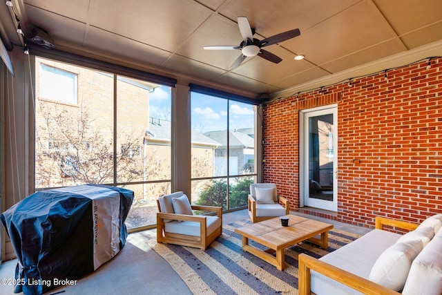 sunroom featuring a ceiling fan