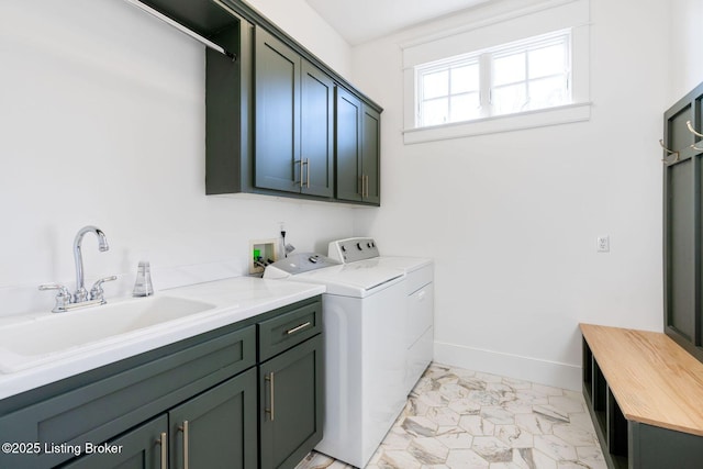 laundry area with marble finish floor, cabinet space, washing machine and dryer, a sink, and baseboards