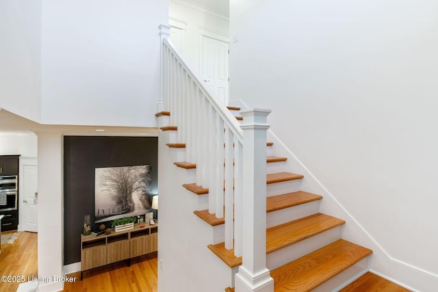 stairway featuring baseboards and wood finished floors