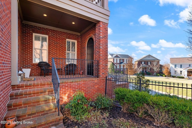 exterior space with brick siding, a patio area, and fence