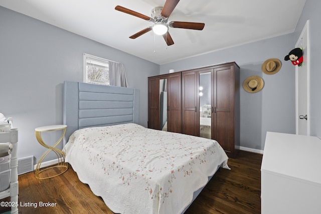 bedroom with a ceiling fan, visible vents, baseboards, and dark wood-type flooring