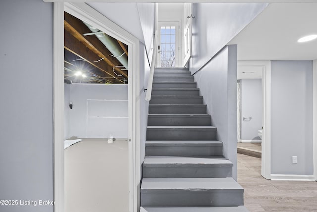 stairs with baseboards and wood finished floors