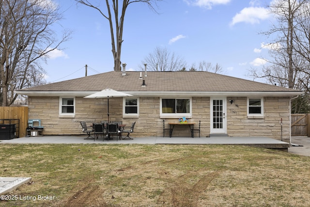 back of house with a patio area, roof with shingles, fence, and a yard