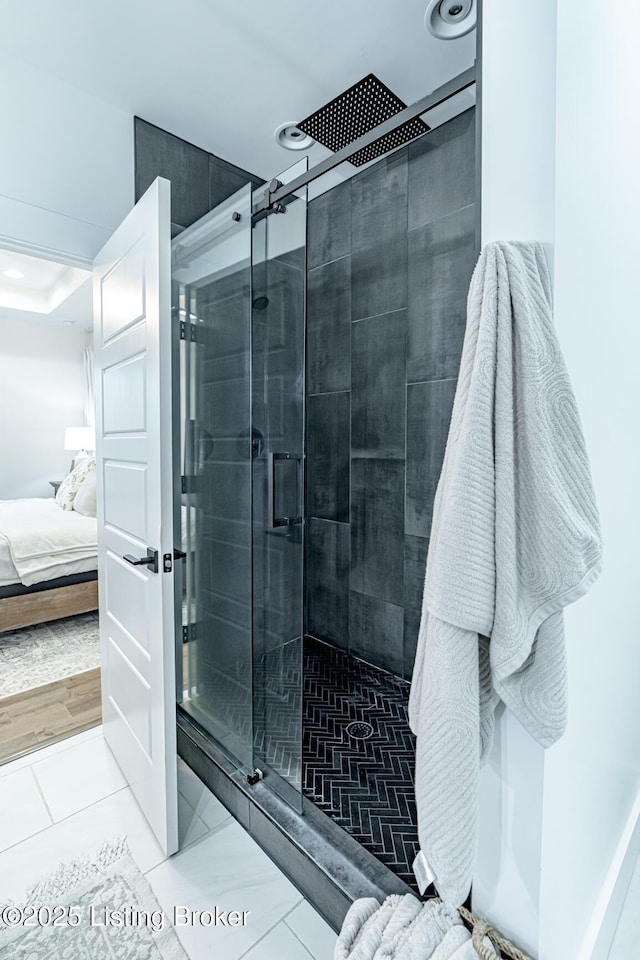 ensuite bathroom featuring a stall shower, ensuite bath, and recessed lighting