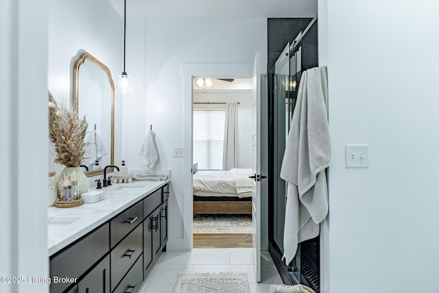 full bath with ensuite bathroom, tile patterned flooring, a sink, double vanity, and a stall shower