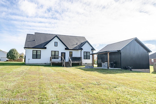 rear view of property with crawl space, roof with shingles, a deck, and a yard