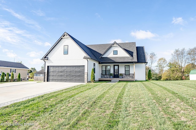 modern farmhouse featuring a porch, concrete driveway, an attached garage, stone siding, and a front lawn