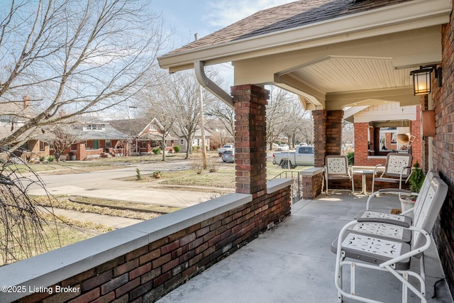 view of patio / terrace with covered porch and a residential view