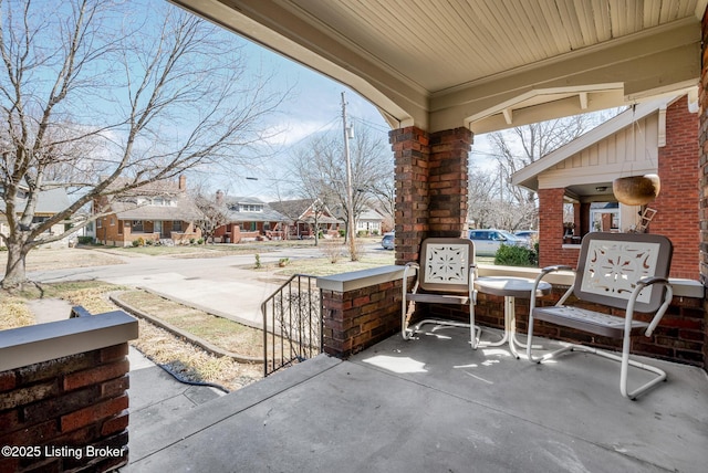 view of patio with a residential view and a porch