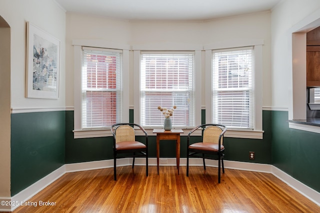 living area featuring baseboards and wood finished floors