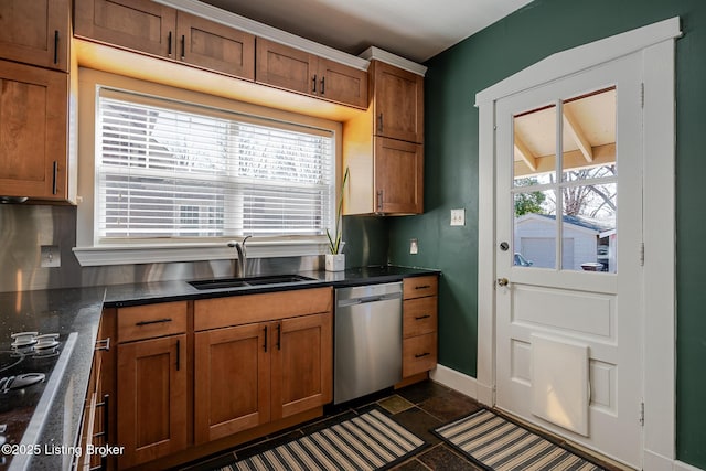 kitchen with brown cabinetry, a healthy amount of sunlight, dishwasher, and a sink