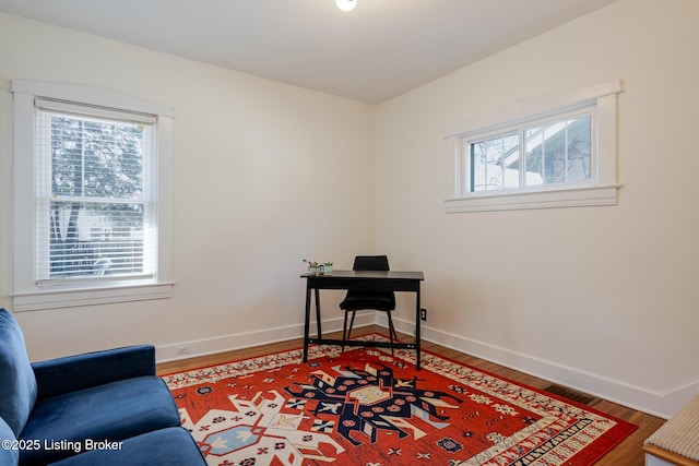 office space featuring wood finished floors and baseboards