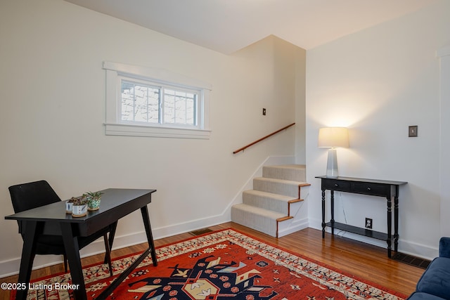 office area featuring baseboards and wood finished floors