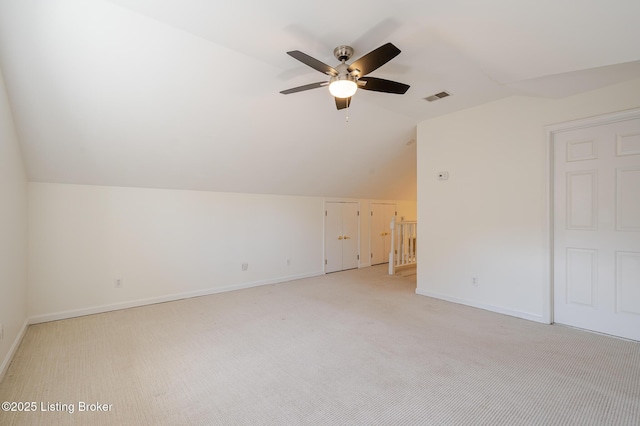 bonus room with visible vents, light carpet, vaulted ceiling, ceiling fan, and baseboards