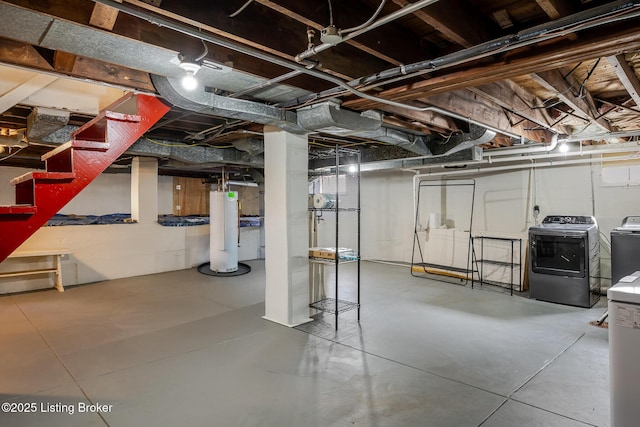 unfinished basement featuring water heater and washing machine and clothes dryer