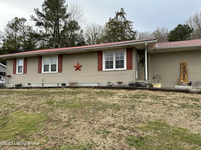 single story home featuring metal roof and a front lawn