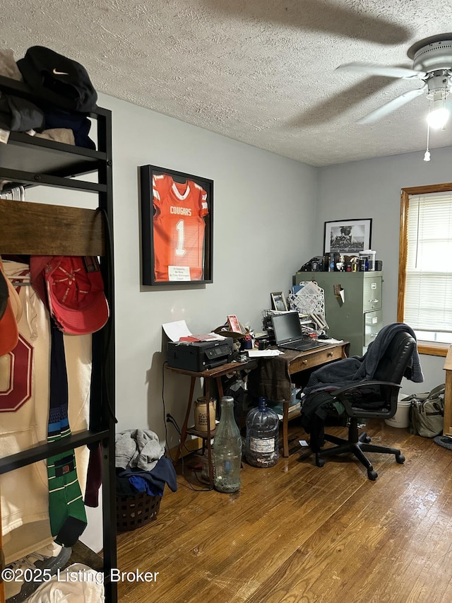 office space featuring ceiling fan, a textured ceiling, and wood finished floors