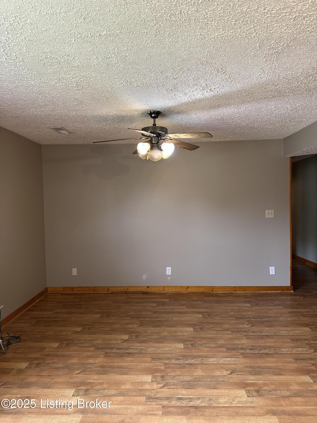 1683 Anneta Rd, Leitchfield, KY 42754 - unfurnished room with a ceiling fan, wood finished floors, baseboards, and a textured ceiling