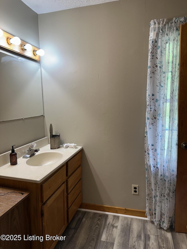 1683 Anneta Rd, Leitchfield, KY 42754 - bathroom with wood finished floors, vanity, and baseboards