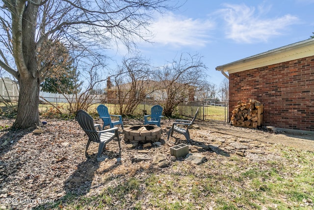 view of yard with a fire pit and fence