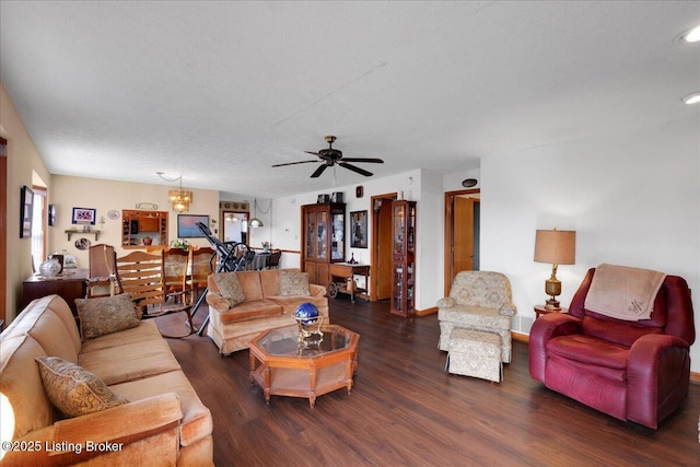 living area with ceiling fan with notable chandelier, a textured ceiling, wood finished floors, and baseboards