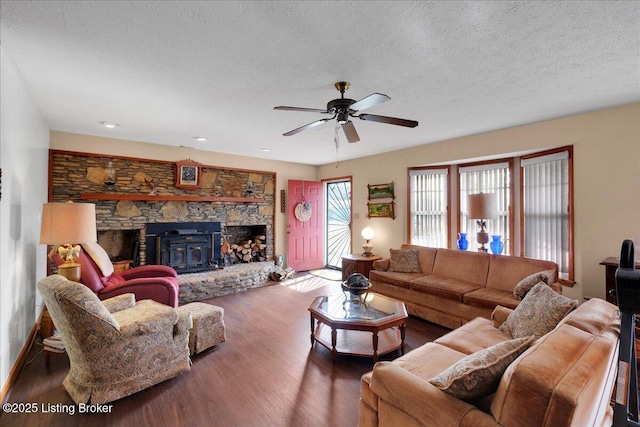 living area featuring a ceiling fan, a textured ceiling, and wood finished floors