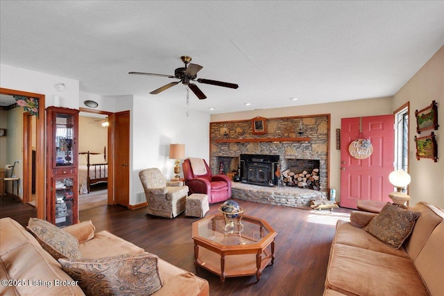 living room featuring a textured ceiling, ceiling fan, and wood finished floors