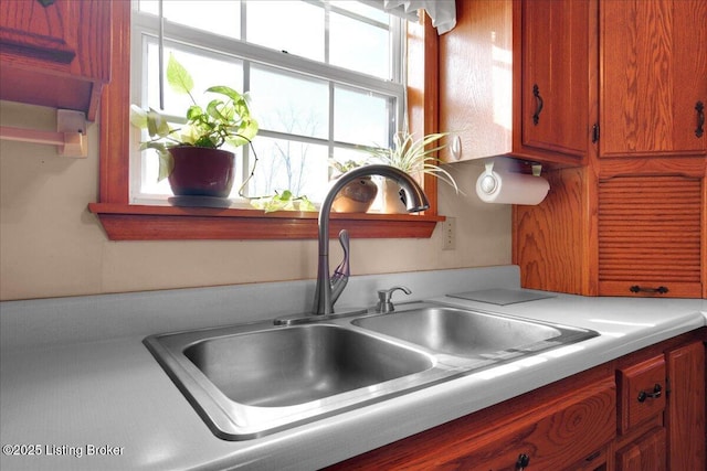 kitchen with light countertops and a sink