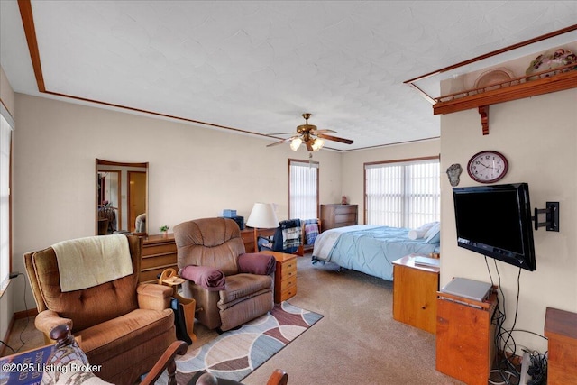 bedroom featuring ceiling fan and carpet