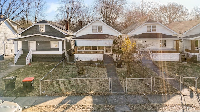 bungalow-style house with a fenced front yard, a gate, and a chimney